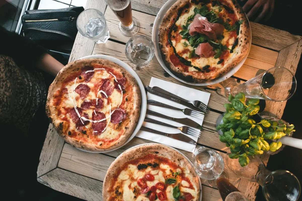 Friends having pizza in a restaurant 1 friends having pizza in a restaurant